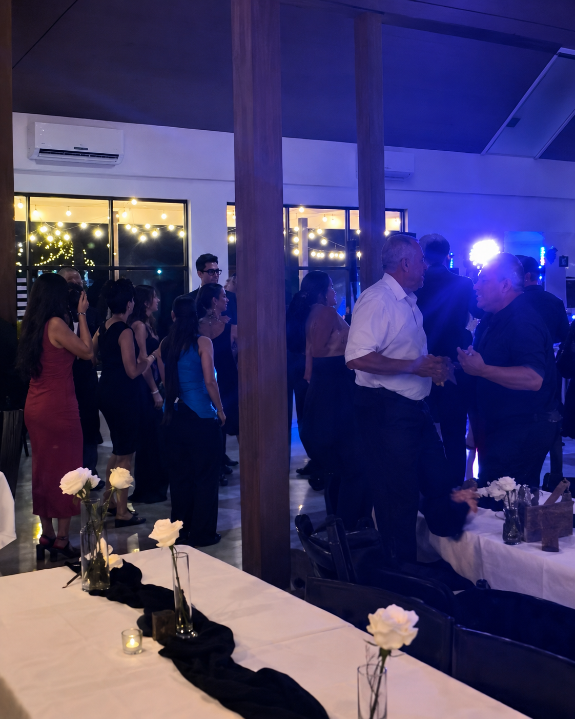 Crowd dancing at a catered indoor event served by What Up Dogz